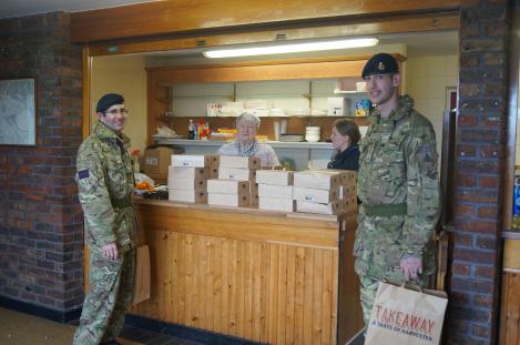 The ladies at the counter giving lunch to the Royal Fusileers generously donated by the local Harvister Restaurant