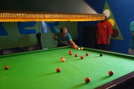 Contestants playin in the snooker room
