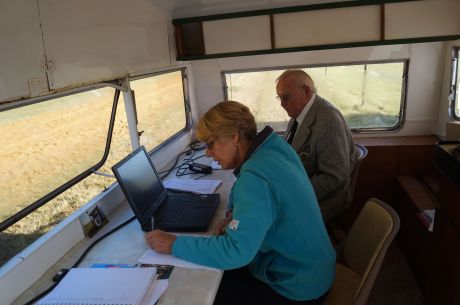 Lions Diane and Harry help with announcements and logging
